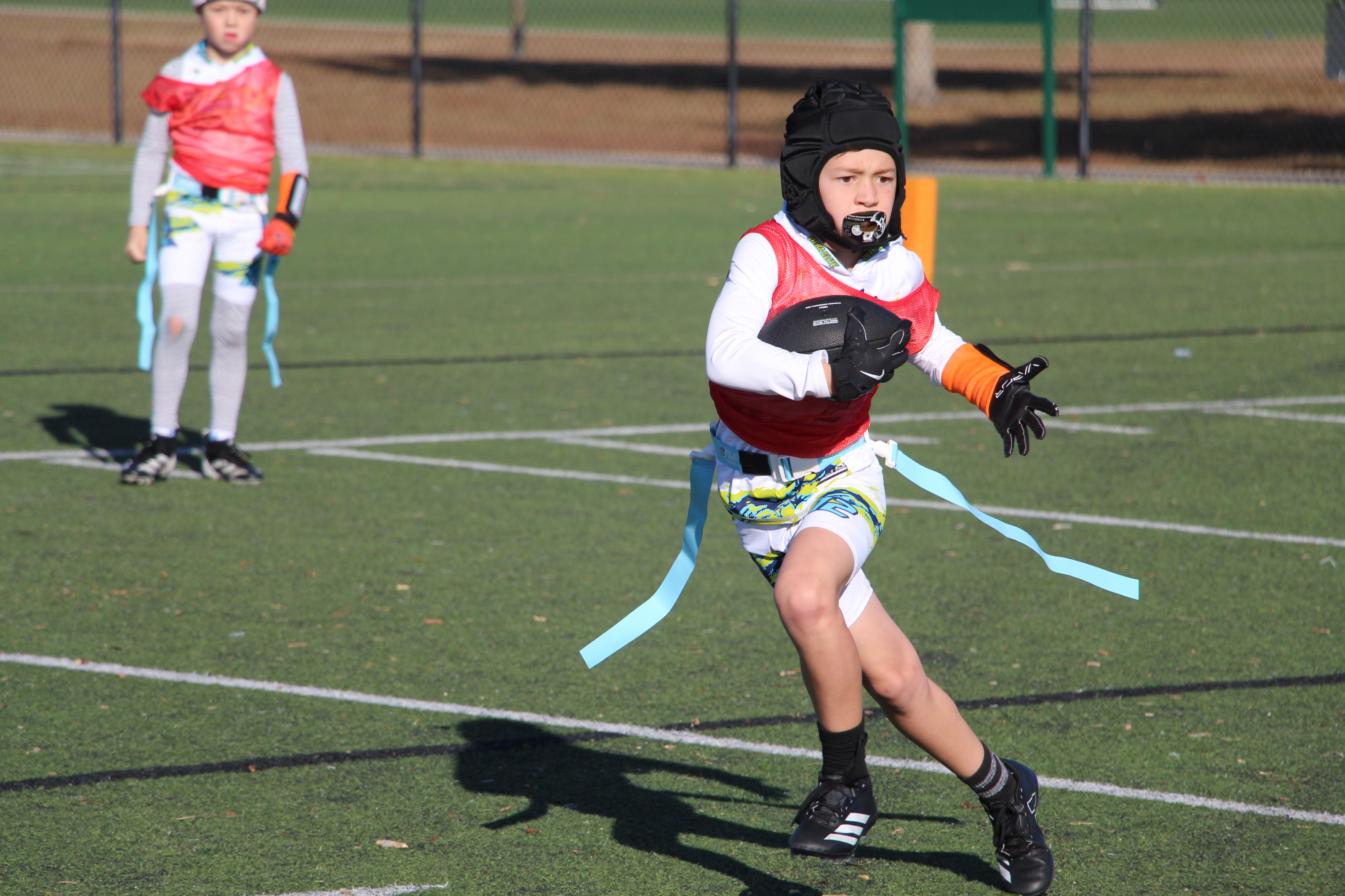 Youth flag football players competing